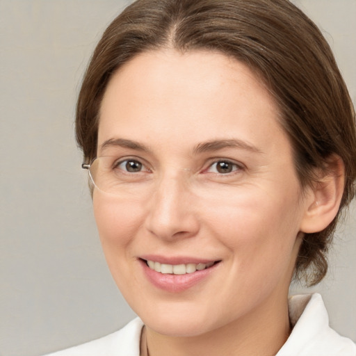 Joyful white adult female with medium  brown hair and brown eyes