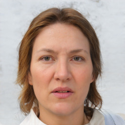 Joyful white adult female with medium  brown hair and grey eyes