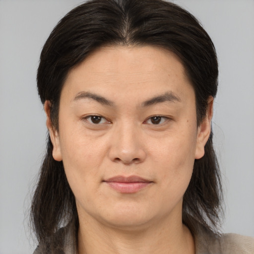 Joyful asian adult female with medium  brown hair and brown eyes