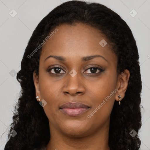 Joyful black young-adult female with long  black hair and brown eyes