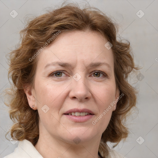 Joyful white adult female with medium  brown hair and blue eyes