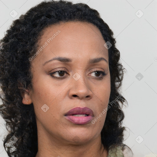 Joyful black adult female with long  brown hair and brown eyes