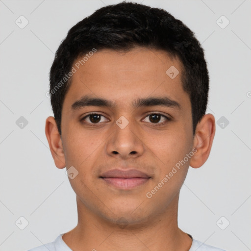 Joyful latino young-adult male with short  brown hair and brown eyes