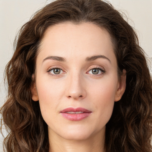 Joyful white young-adult female with long  brown hair and green eyes