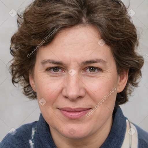 Joyful white adult female with medium  brown hair and blue eyes