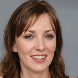 Joyful white young-adult female with medium  brown hair and blue eyes