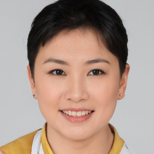 Joyful asian young-adult female with short  brown hair and brown eyes