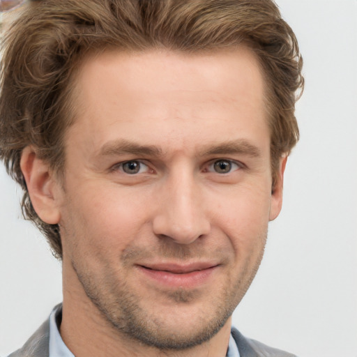 Joyful white adult male with short  brown hair and grey eyes