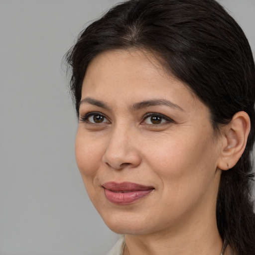 Joyful white adult female with medium  brown hair and brown eyes