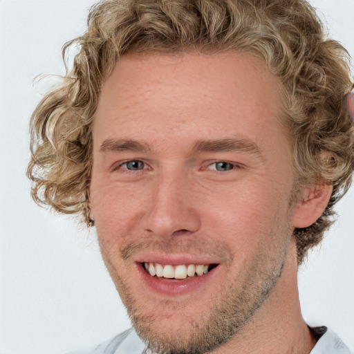 Joyful white adult male with short  brown hair and blue eyes