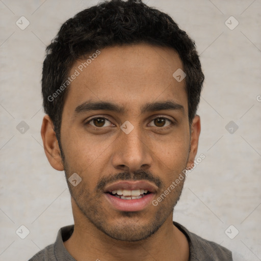 Joyful white young-adult male with short  black hair and brown eyes