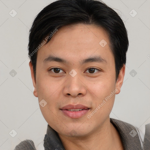 Joyful asian young-adult male with short  black hair and brown eyes