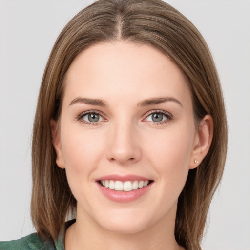 Joyful white young-adult female with medium  brown hair and grey eyes