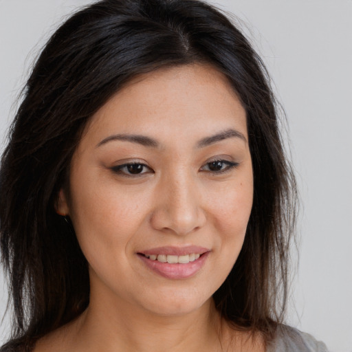 Joyful white young-adult female with long  brown hair and brown eyes