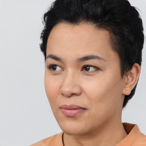 Joyful asian young-adult female with short  black hair and brown eyes