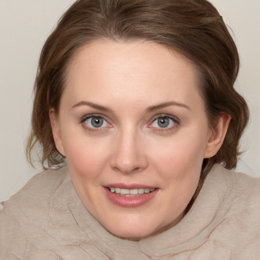 Joyful white young-adult female with medium  brown hair and green eyes