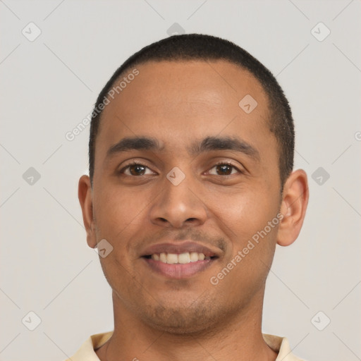 Joyful latino young-adult male with short  black hair and brown eyes