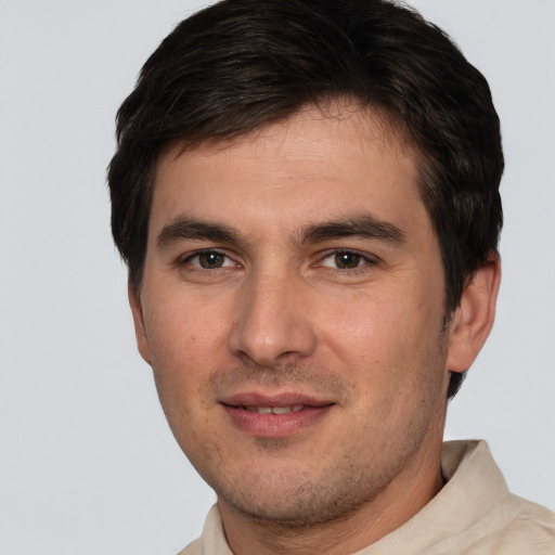 Joyful white young-adult male with short  brown hair and brown eyes