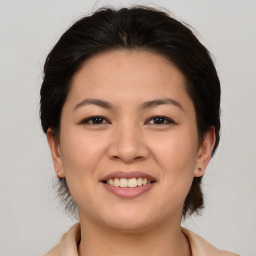 Joyful asian young-adult female with medium  brown hair and brown eyes