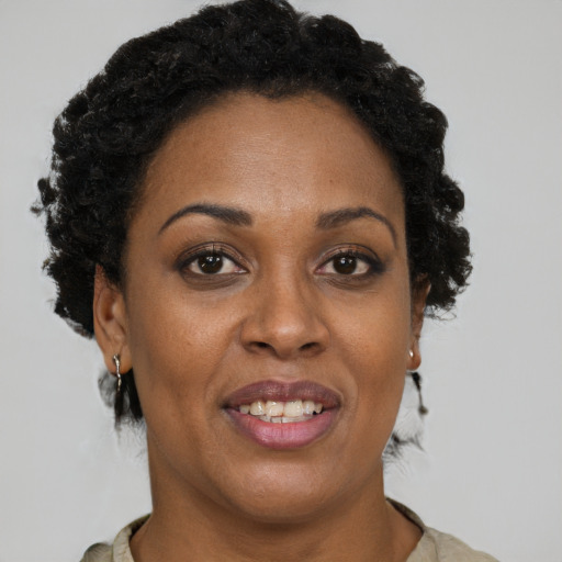 Joyful black adult female with short  brown hair and brown eyes