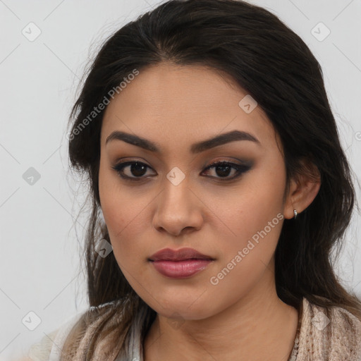 Joyful latino young-adult female with long  brown hair and brown eyes