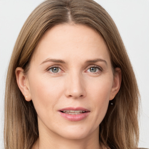 Joyful white young-adult female with long  brown hair and grey eyes