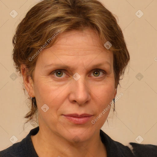 Joyful white adult female with medium  brown hair and blue eyes