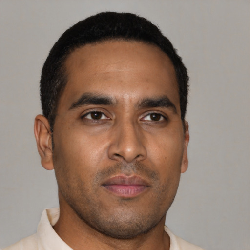 Neutral latino young-adult male with short  brown hair and brown eyes