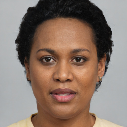 Joyful latino adult female with short  black hair and brown eyes