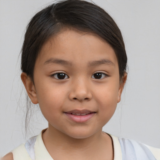 Joyful latino child female with medium  brown hair and brown eyes