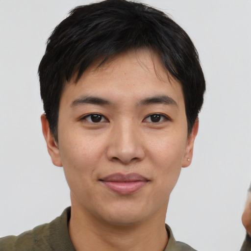 Joyful asian young-adult male with short  black hair and brown eyes
