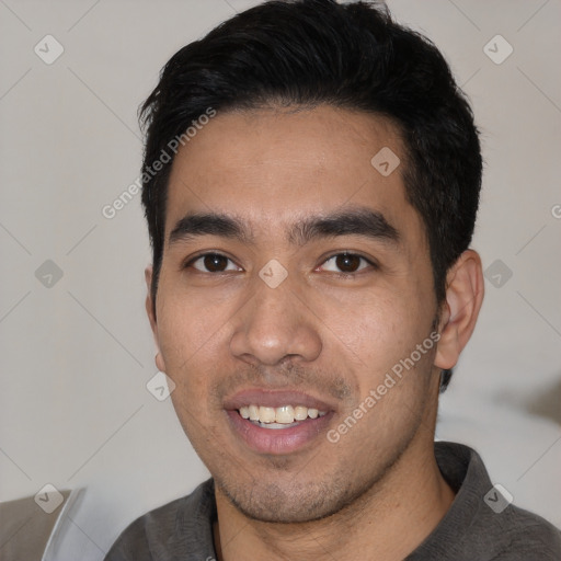 Joyful white young-adult male with short  black hair and brown eyes