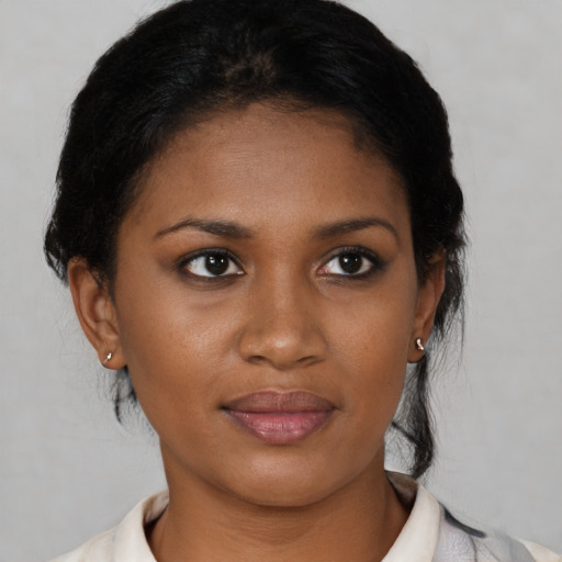 Joyful black young-adult female with medium  black hair and brown eyes