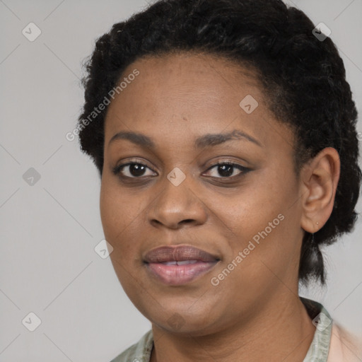 Joyful black adult female with short  black hair and brown eyes