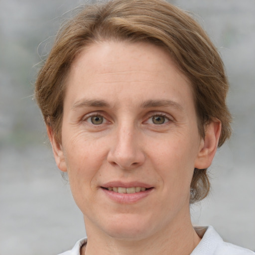 Joyful white adult female with medium  brown hair and grey eyes