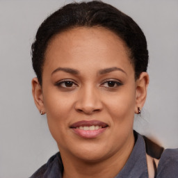 Joyful latino young-adult female with short  brown hair and brown eyes