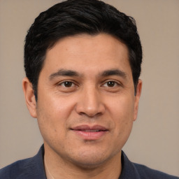 Joyful white young-adult male with short  black hair and brown eyes