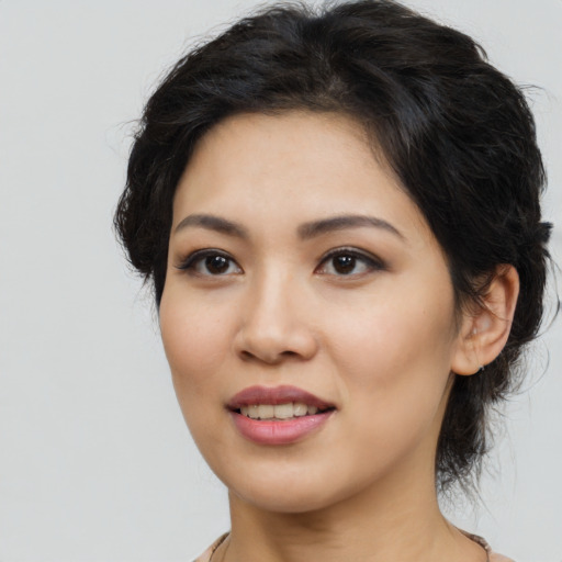 Joyful asian young-adult female with long  brown hair and brown eyes