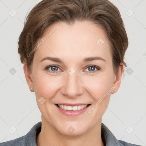 Joyful white young-adult female with short  brown hair and grey eyes