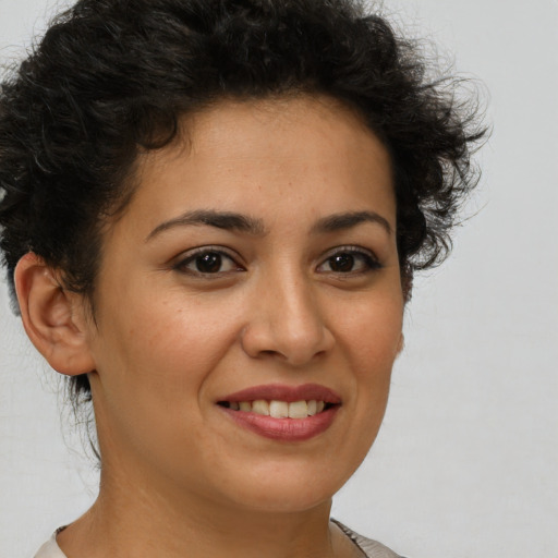 Joyful latino young-adult female with short  brown hair and brown eyes