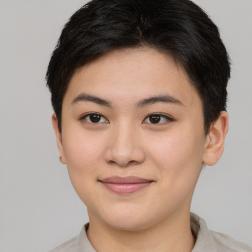 Joyful asian young-adult female with short  brown hair and brown eyes
