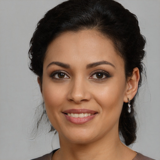 Joyful latino young-adult female with medium  brown hair and brown eyes