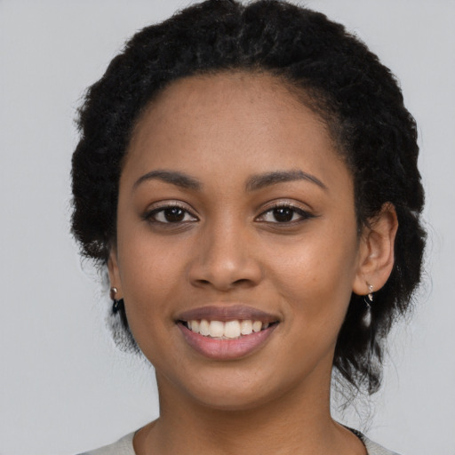 Joyful latino young-adult female with long  black hair and brown eyes