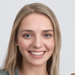 Joyful white young-adult female with long  brown hair and blue eyes