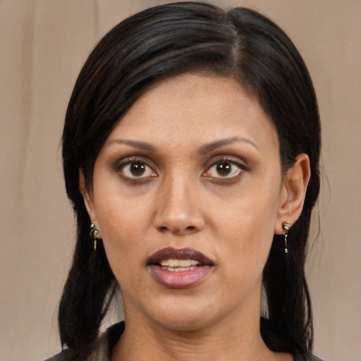 Joyful latino adult female with long  black hair and brown eyes