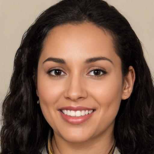 Joyful latino young-adult female with long  brown hair and brown eyes