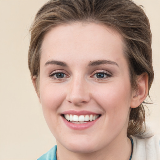 Joyful white young-adult female with medium  brown hair and green eyes