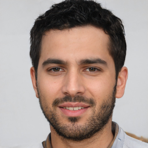 Joyful white young-adult male with short  black hair and brown eyes