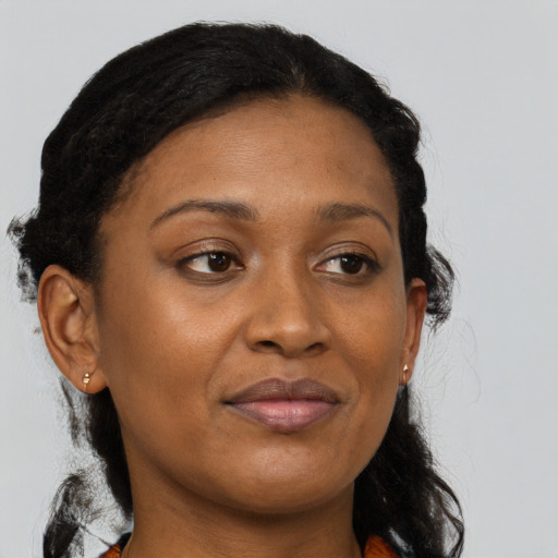 Joyful black adult female with medium  brown hair and brown eyes