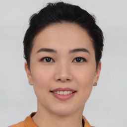 Joyful asian young-adult female with short  black hair and brown eyes